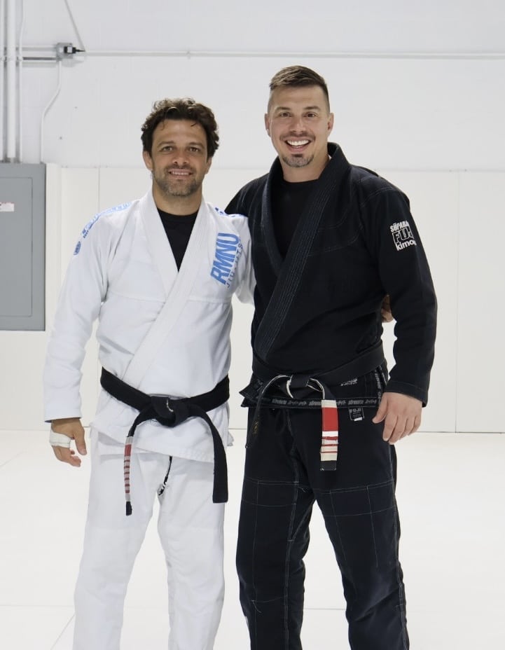 North Side Brazilian jiu Jitsu instructor smiling with student wearing gi uniforms.